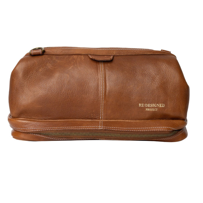 Luxurious walnut leather knitting bag with compartments for needles, notions, and an adjustable strap.