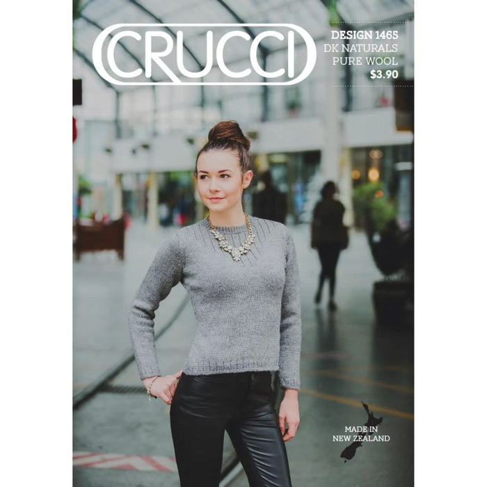 Woman wearing a classic grey sweater knitted with Crucci DK Naturals wool.