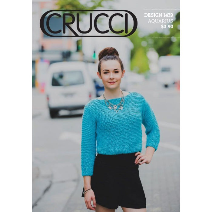 Cropped blue garter sweater on a model, knitting pattern CRU1479 by Crucci.