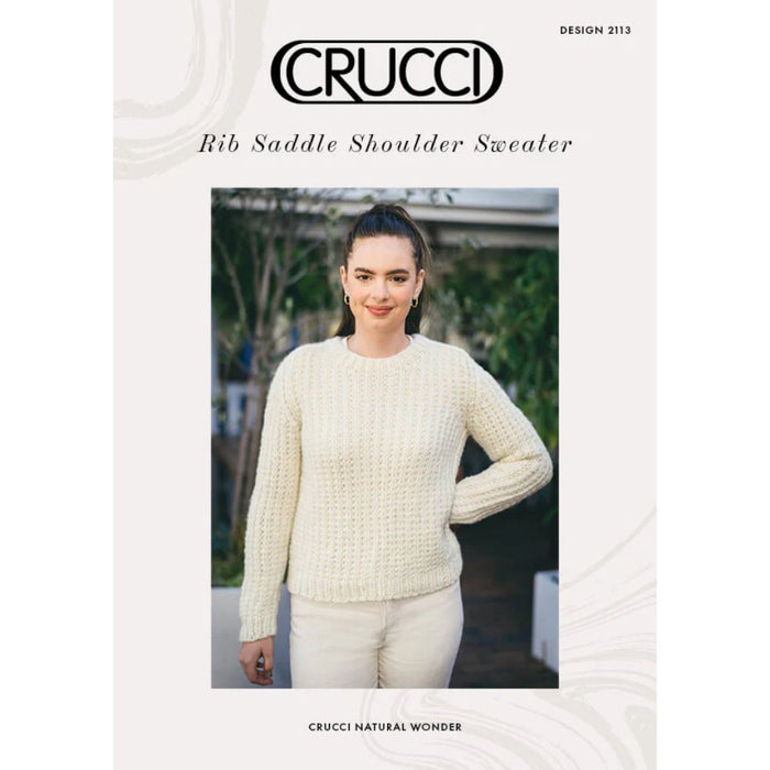 Rib saddle shoulder sweater knitting pattern CRU2113 cover, featuring a woman in a cream sweater.