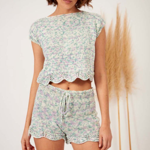 Zoe Romper Set Knitting Pattern in Amano Inti yarn, intermediate-level with lace details, featuring sweater and shorts.