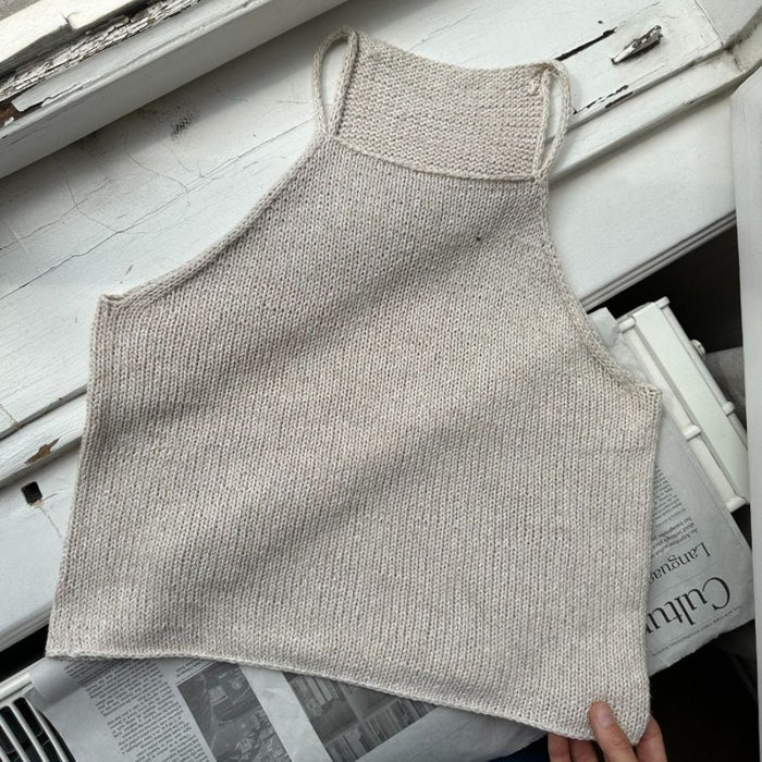 Knitted Audrey Top laid flat, showcasing stockinette stitch and i-cord straps from PetiteKnit.
