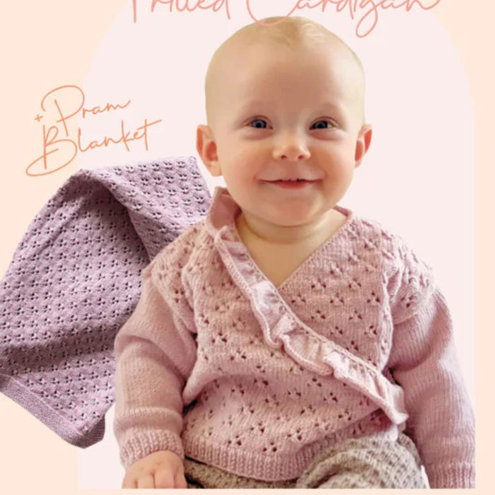 Baby wearing frilled cardigan; pram blanket in background; knitting pattern CRU2317.