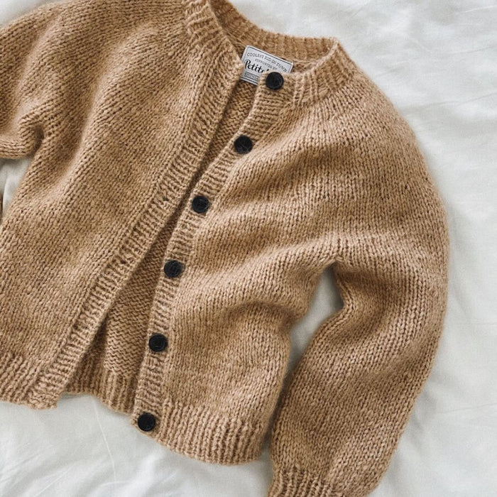 Novice Cardigan Junior Chunky Edition by PetiteKnit displayed on a white surface.