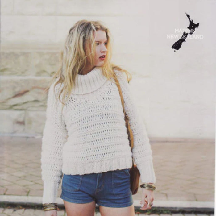 High neck roll collar sweater in white, worn by model, designed for knitting with Crucci 14 Ply Pure Wool.