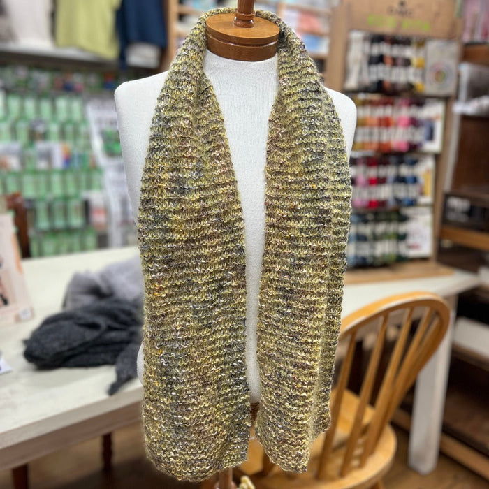 Vibrant Bliss Scarf Knitting Pattern displayed on a mannequin in a craft store setting.