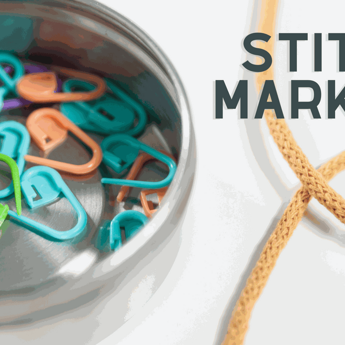 colorful plastic locking stitch markers for knitting on a white background