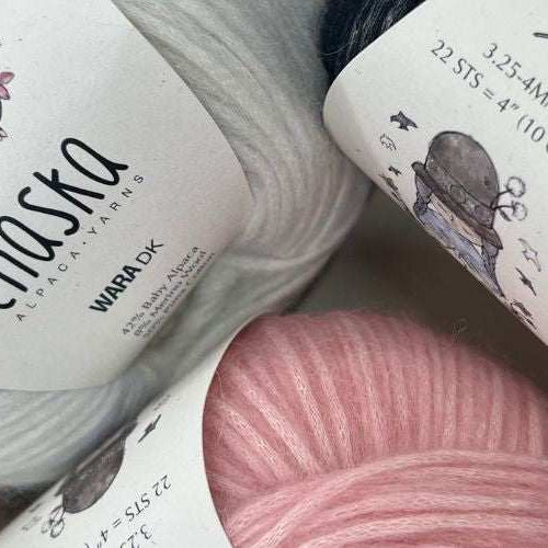 Close-up of soft, fluffy blown yarns made from baby alpaca, merino wool, and Pima cotton