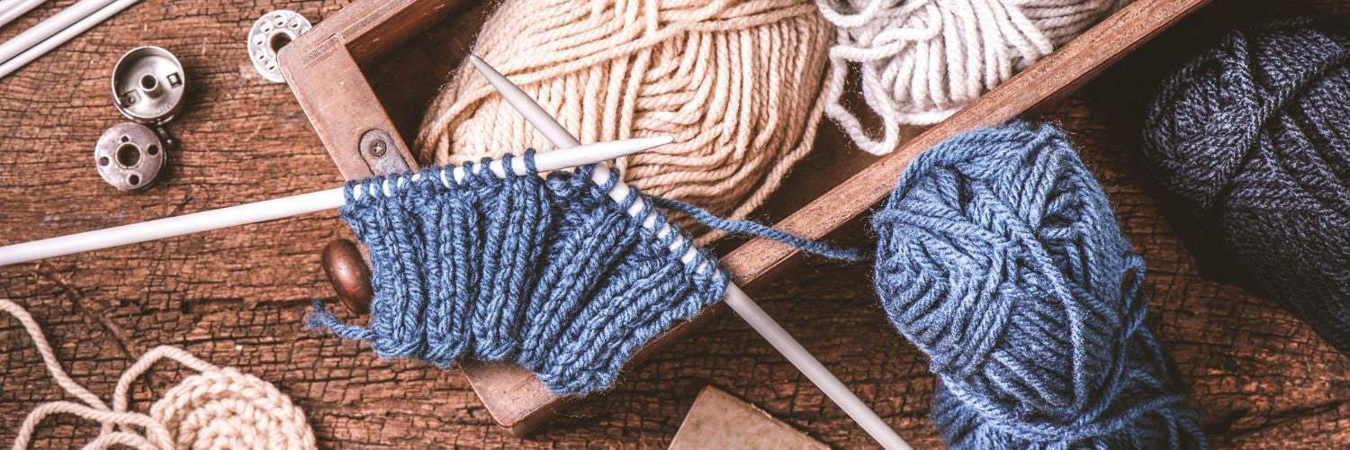 Beginner knitter fixing common knitting mistakes with yarn and needles