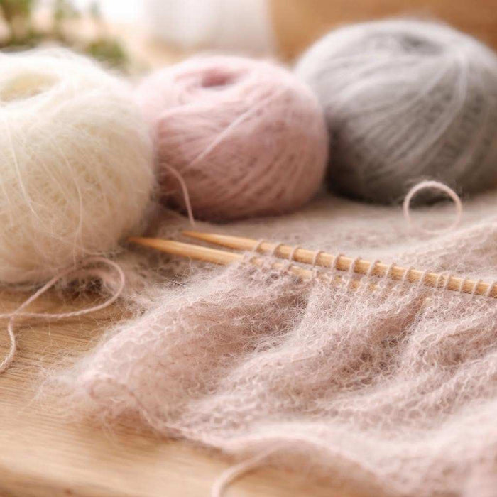 Close-up of mohair thread revealing its distinctive soft halo effect and fine texture for knitting projects