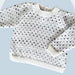 Children's v-neck top-down sweater with greywacke naturals 4ply yarn and all-over dot pattern