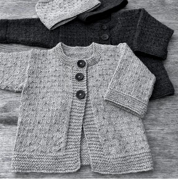 Baby wearing Mika Petite knitted cardigan and hat set in soft Merino 4ply yarn