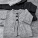Baby wearing Mika Petite knitted cardigan and hat set in soft Merino 4ply yarn