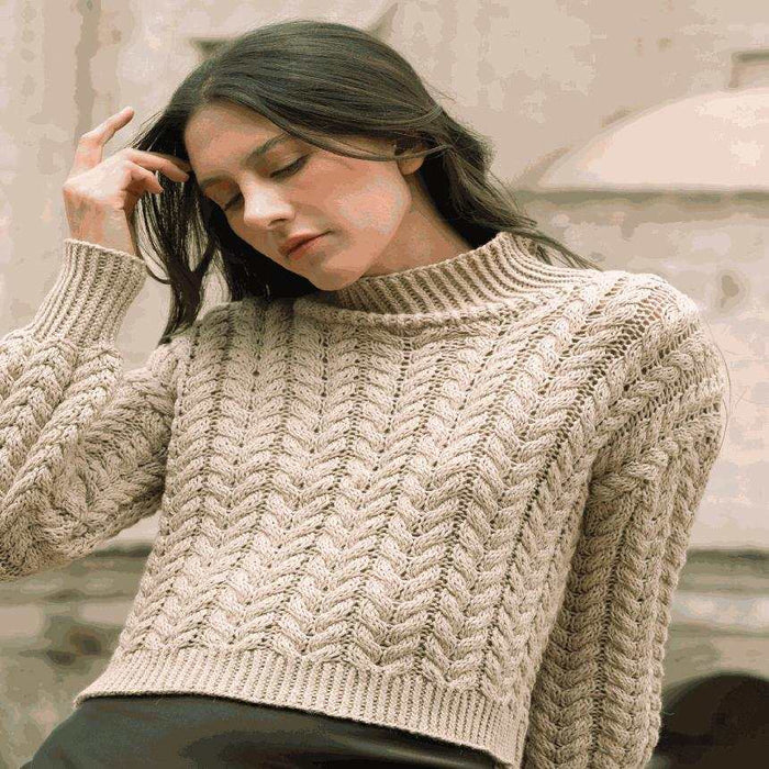 Soraya pullover knitting pattern featuring all-over cable design and twisted-rib trims in Amano Duna Rawi yarn
