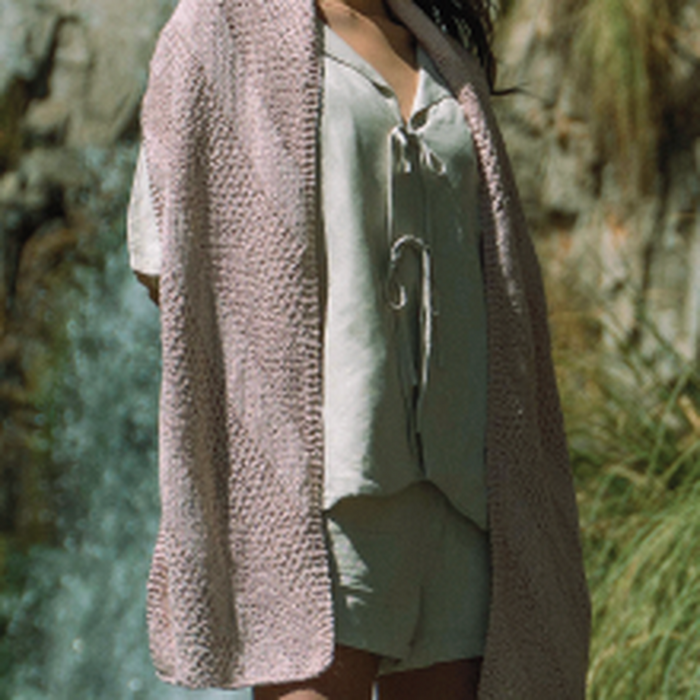 Long rectangular Ulta Shawl knitted in textured organic cotton with repeating stitch pattern