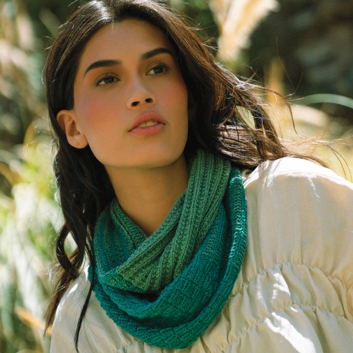 Reversible two-colour Olga Cowl knitted with slip-stitch texture and three-needle finish in Amano Duna yarn