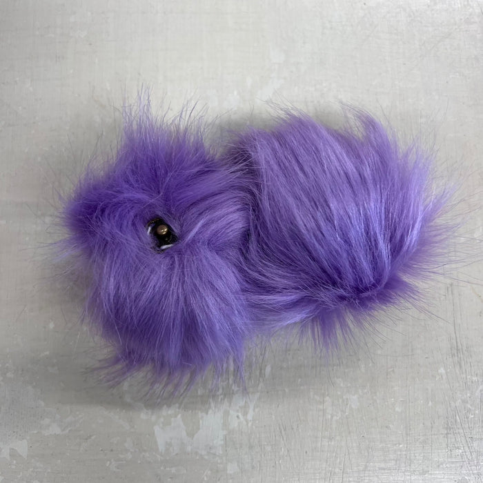 Faux fur pom pom with snap fastener, approximately 10cm, in purple color.