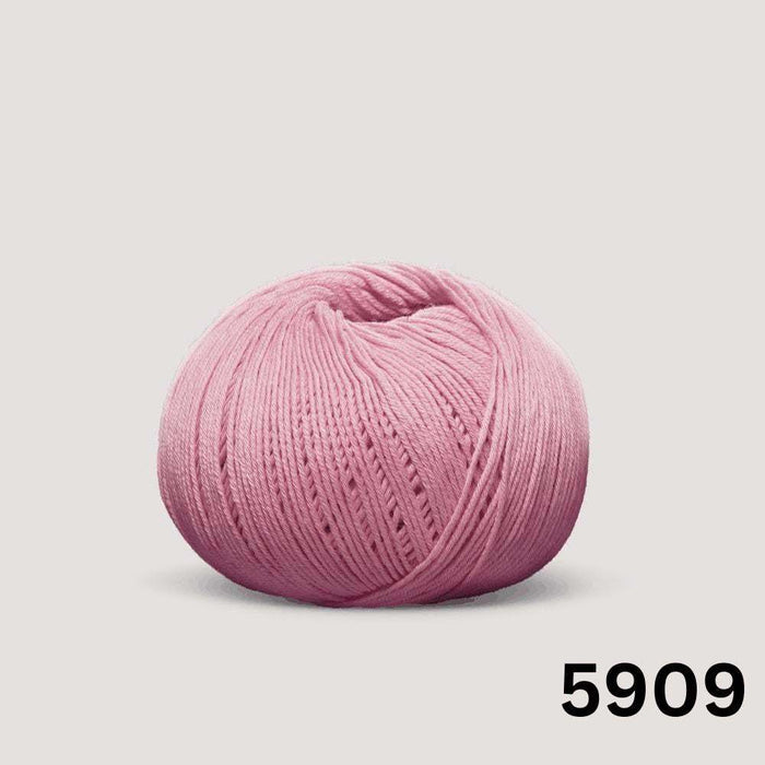 Summer Raglan Cardigan & Hat Knit Kit featuring a ball of smooth pink cotton yarn with a neatly wound texture.