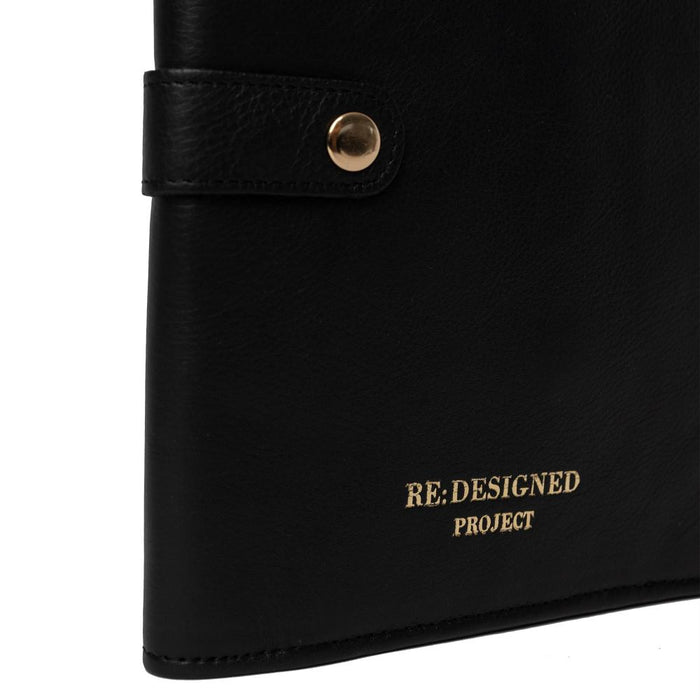 Black and gold leather interchangeable knitting needle case with snap closure, ideal for organization and portability.