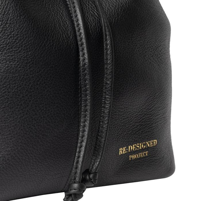 Black and gold genuine leather knitting bucket bag with adjustable strap.