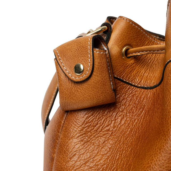 Genuine leather knitting bag in burned tan with gold accents and adjustable strap.