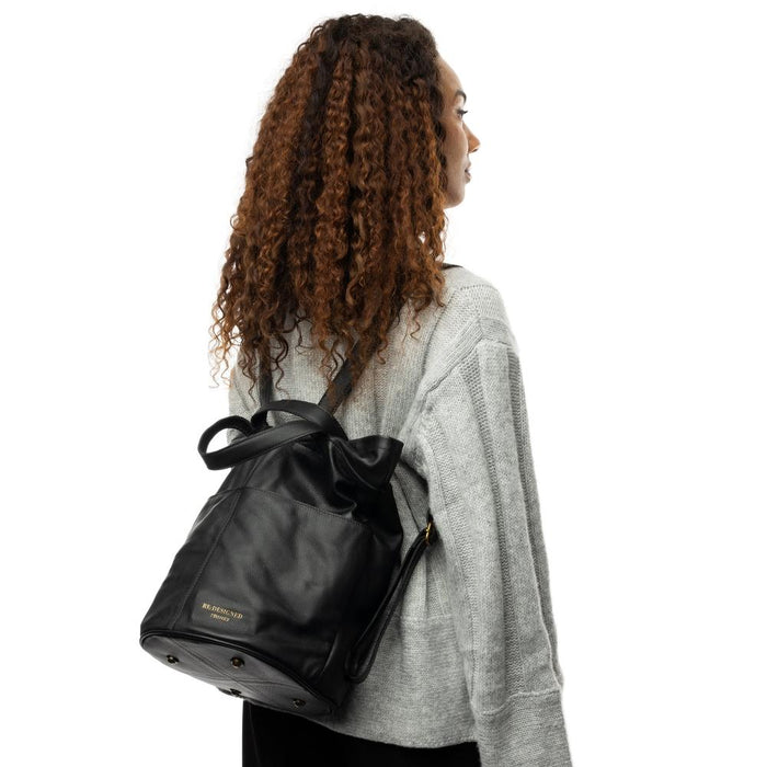 Black leather Project 24 backpack, ideal knitting bag with multiple pockets for yarn and accessories, handcrafted for style and organization.