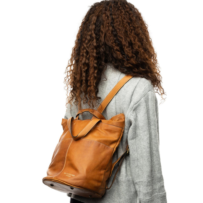 Project 24 Project Backpack in Burned Tan worn by person; handcrafted with multiple pockets, spacious leather design.