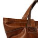 Walnut leather knitting backpack with multiple pockets for organization.