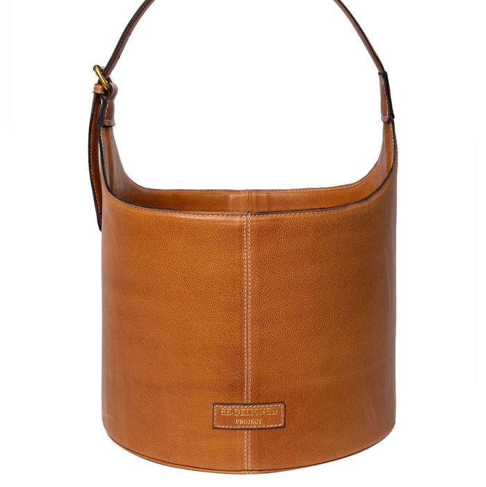 Project 26 Small Bucket Bag in Burned Tan leather with a minimalist design and sturdy handle.