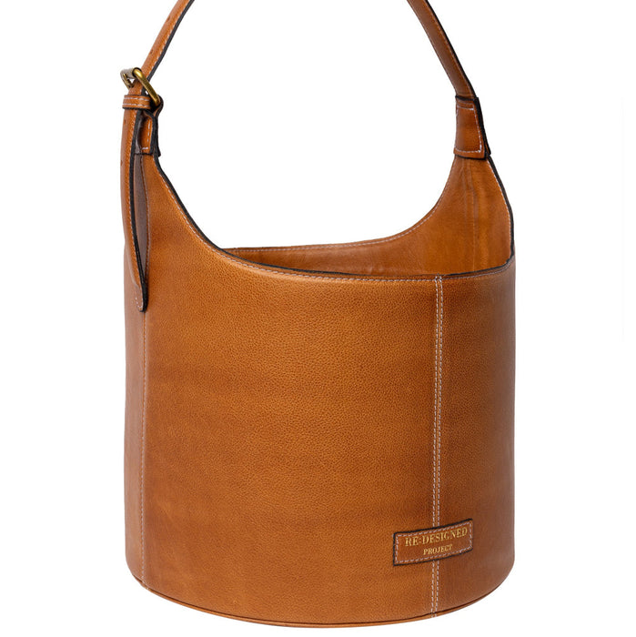 Small leather bucket bag in burned tan color with a sturdy handle, ideal for stylish storage and easy portability.
