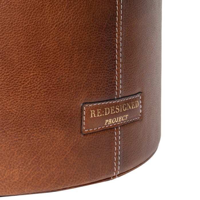 Small bucket bag walnut leather close-up showing stitching and texture.