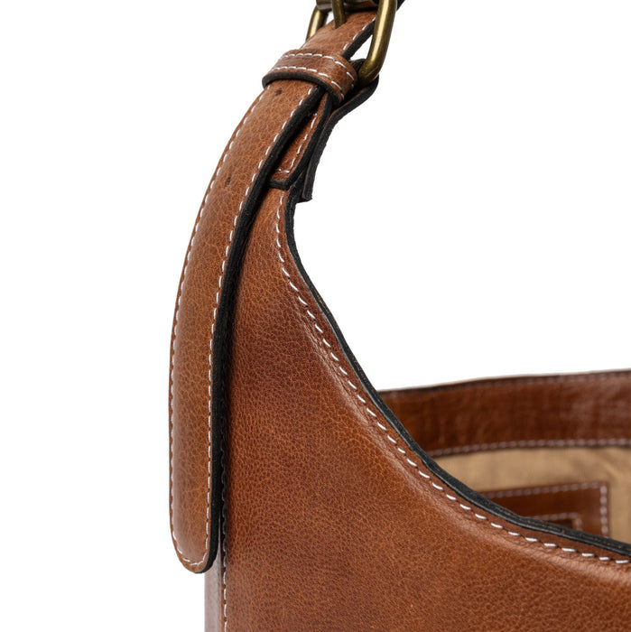 Small walnut leather bucket bag with a sturdy handle, showcasing minimalist design and smooth finish.