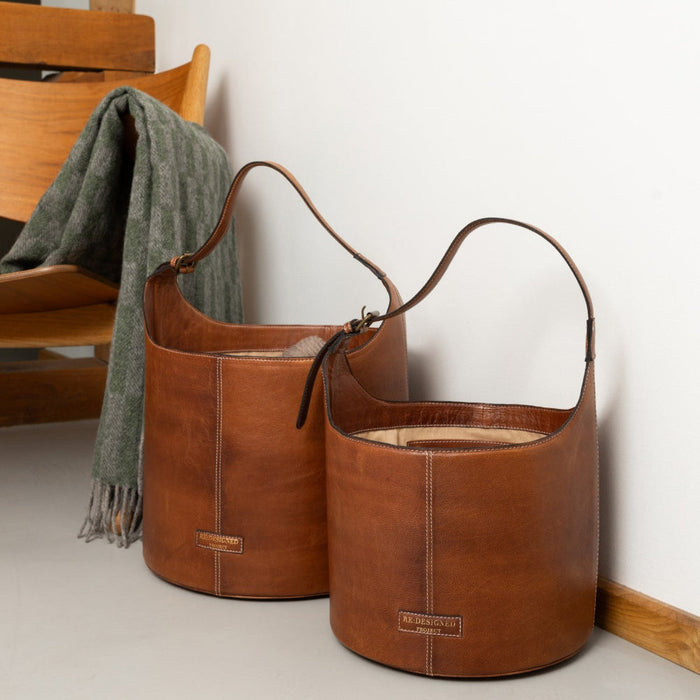 Small bucket bag in walnut leather, designed for style and practicality, featuring a sturdy structure and comfortable handle, perfect for knitters.