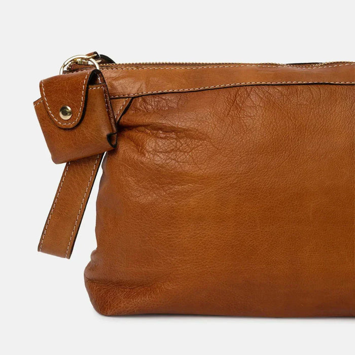 Large burnt tan and gold leather knitting bag with zipper, open pockets, and side handle for yarn and accessories.