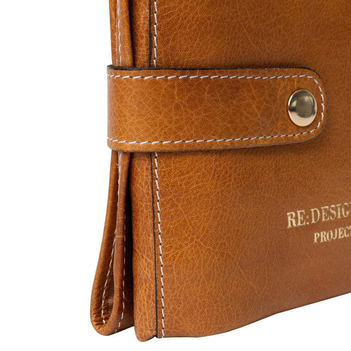 Knitting bag in burned tan leather with gold snap button, featuring small pockets and compartments.