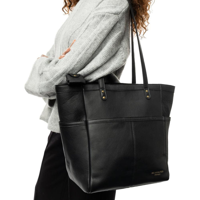 Black leather knitting project bag with shoulder handles, zip closure, compartments, and keyring.