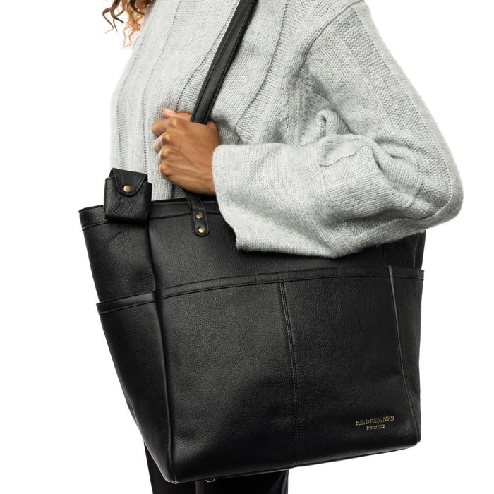 Black leather Project 37 knitting bag with shoulder handles and compartments.