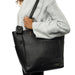 Black leather Project 37 knitting bag with shoulder handles and compartments.