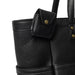Black leather knitting project bag with compartments and shoulder handles.