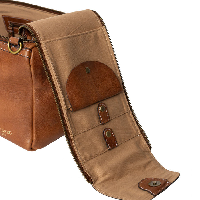 Knitting bag in walnut leather with multiple pockets and zippers.