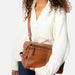 Walnut leather knitting bag with side handle and adjustable strap.