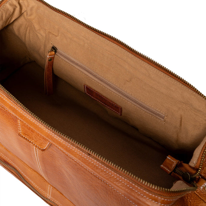 Luxurious leather knitting bag in burned tan with compartments for needles and notions, adjustable strap.