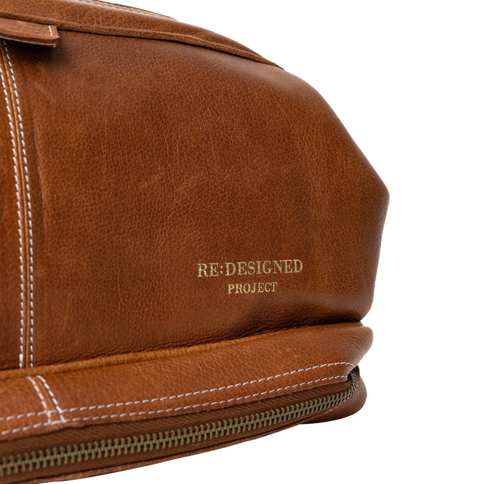 Luxurious walnut leather knitting bag with needle compartments and adjustable strap.