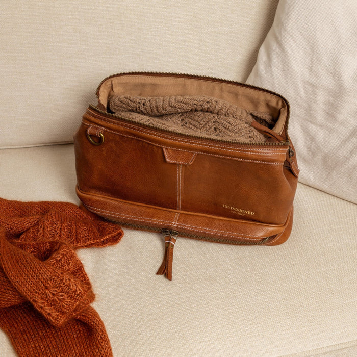 Knitting bag in walnut leather with compartments and optional shoulder strap.