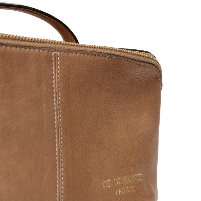 Taupe leather knitting project bag with elegant design and dedicated spaces for tools and supplies.