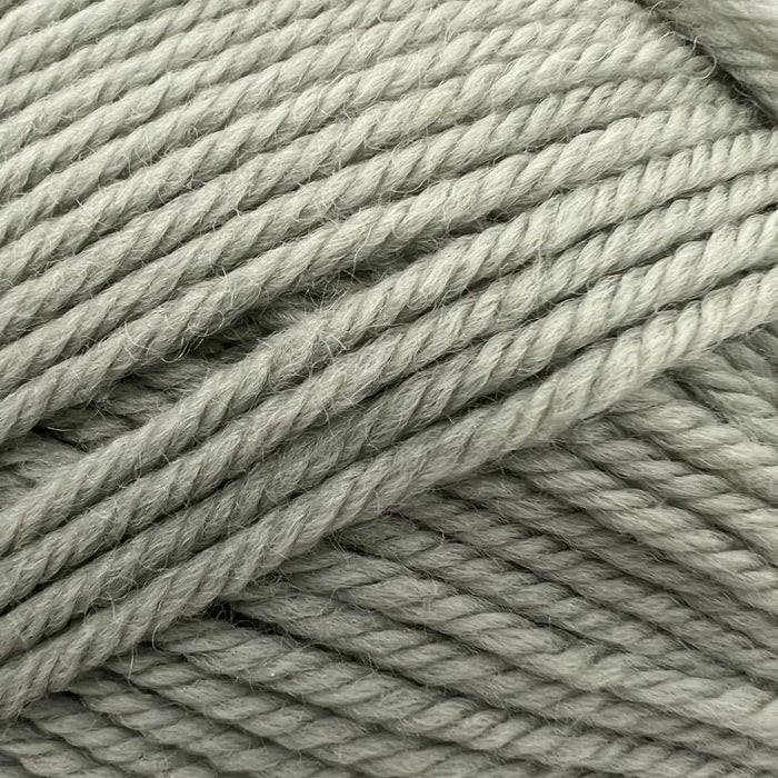 Close-up of soft 8ply merino wool yarn in sage green, part of the Goldie Sweater & Hat Knit Kit.