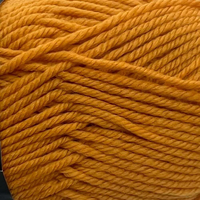 Close-up of gold-colored 8ply merino wool yarn for the Goldie Sweater & Hat Knit Kit.