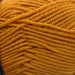 Close-up of gold-colored 8ply merino wool yarn for the Goldie Sweater & Hat Knit Kit.