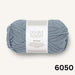 Beige knitted children's vest from Sille Slipover Mini Knitting Kit with textured stitch pattern and ribbed edges.