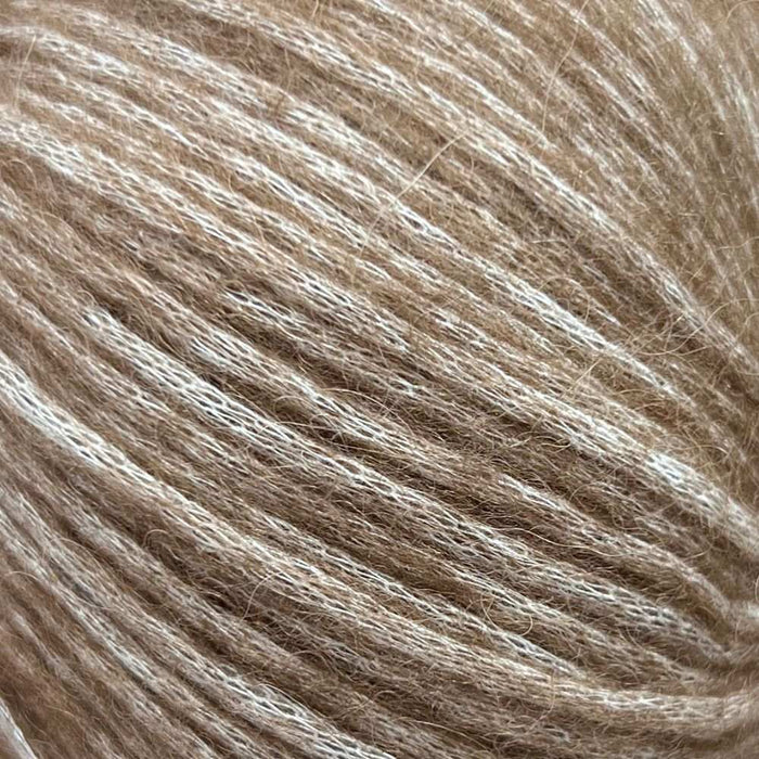Luxurious Chaska Wara yarn close-up showing soft, fluffy fibers in a light brown shade for knitting projects.
